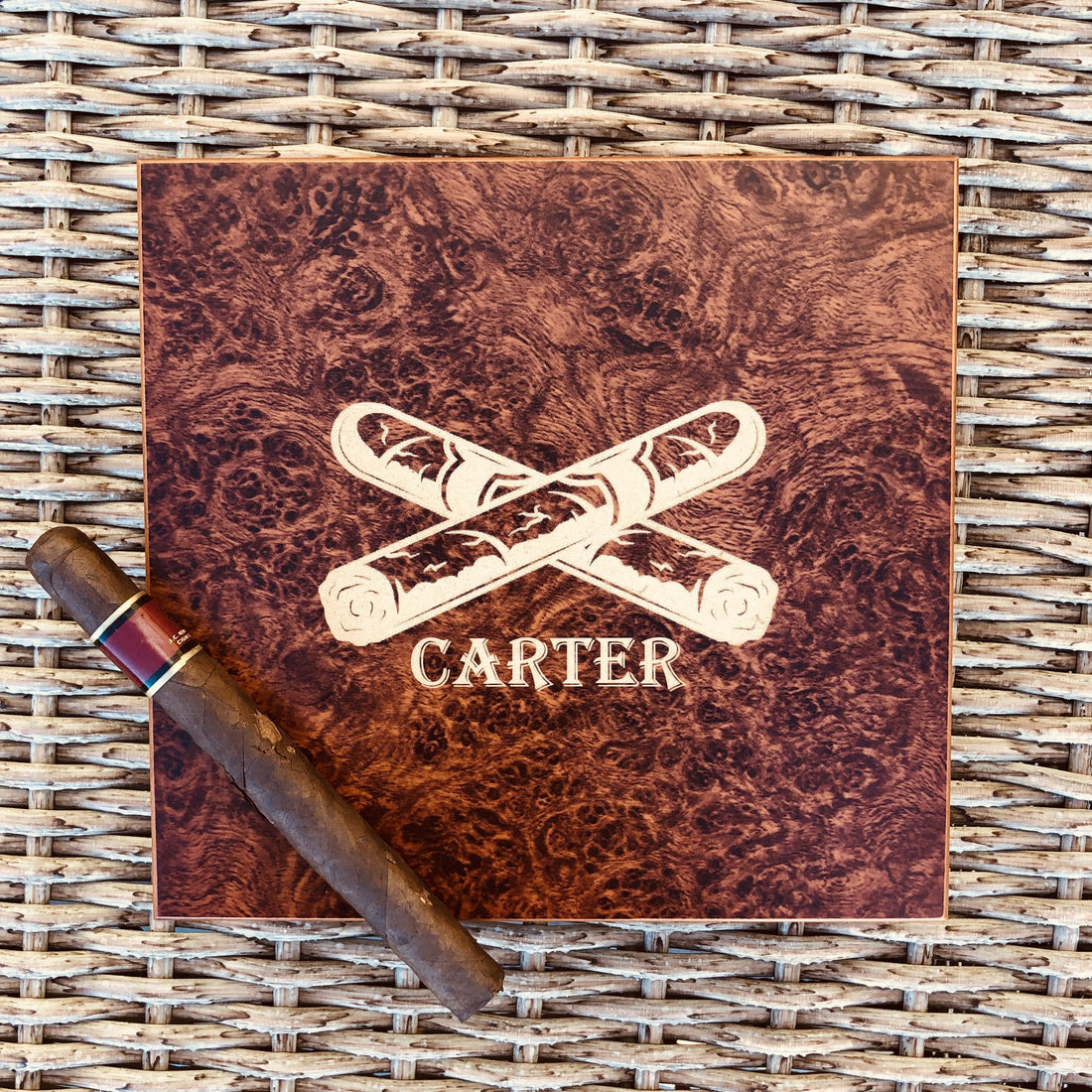 Burl wood cigar humidor engraved with the name Carter and a crossed cigars emblem, a compact personalized mini humidor for a first collection or desk